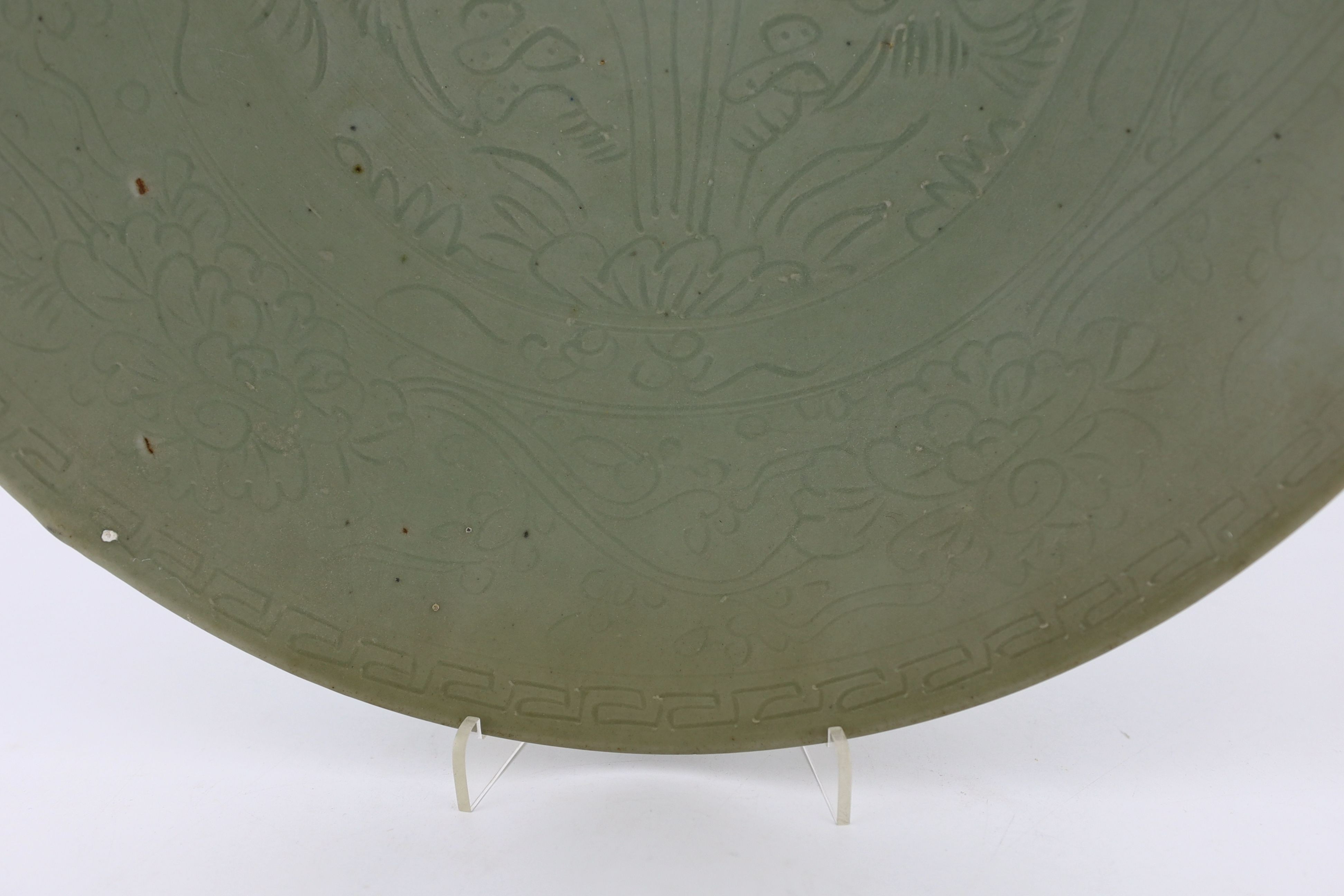 A Chinese celadon glazed sgraffito dish, Zhangzhou kilns, late 16th/early 17th century, 37cm diameter